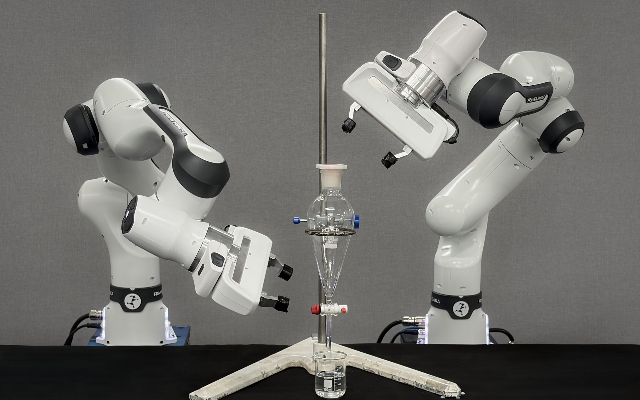 Two Franka robot arms assembling a separating-funnel apparatus