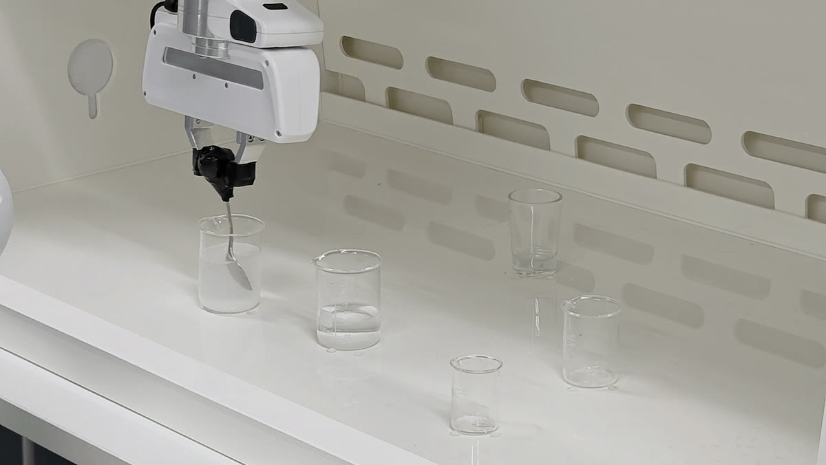 Franka stirring liquid in a beaker